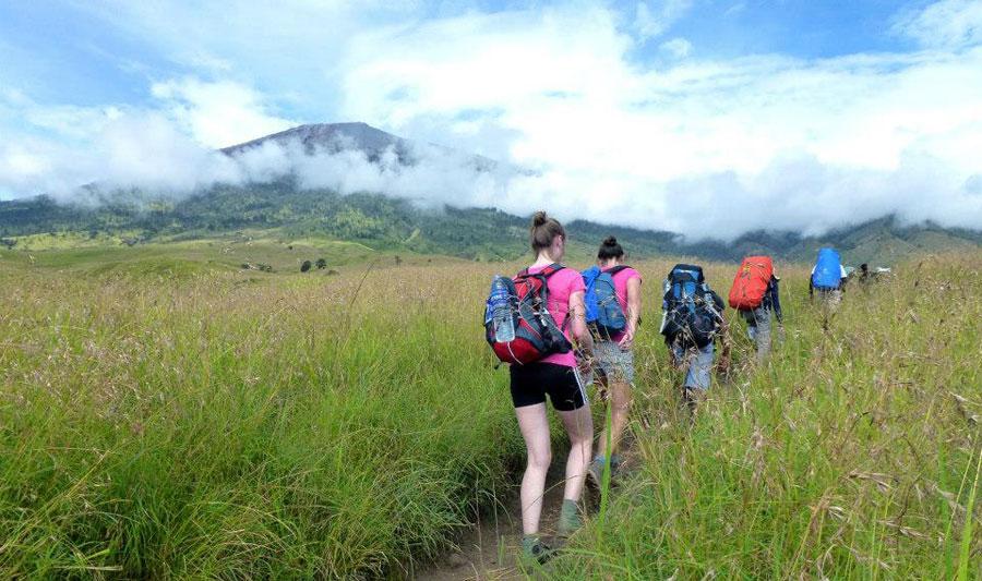 Tents and trekkers at Sembalun Crater Rim campsite on Mount Rinjani